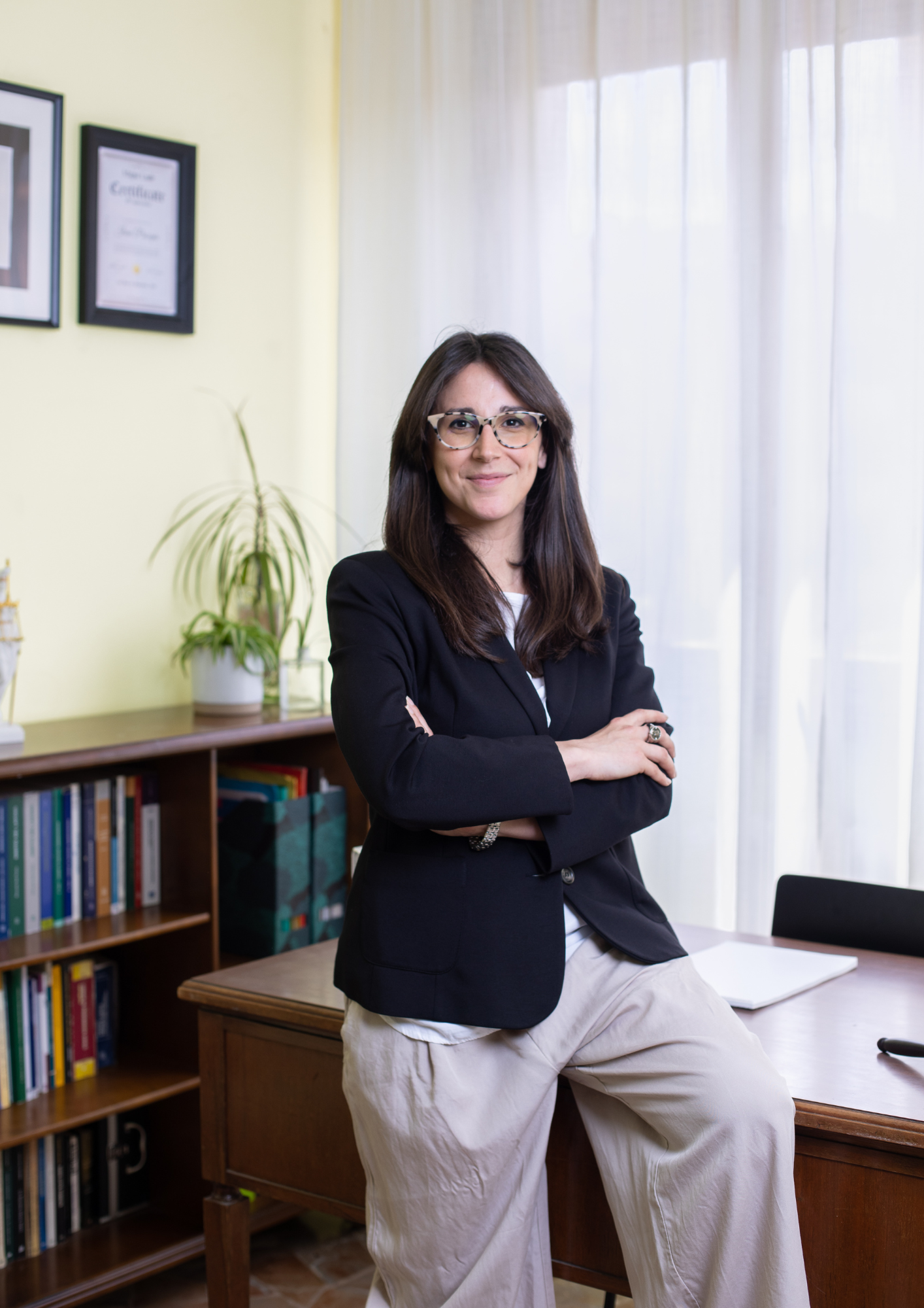 Confident female lawyer standing in her office, ready to assist clients with expert legal guidance.