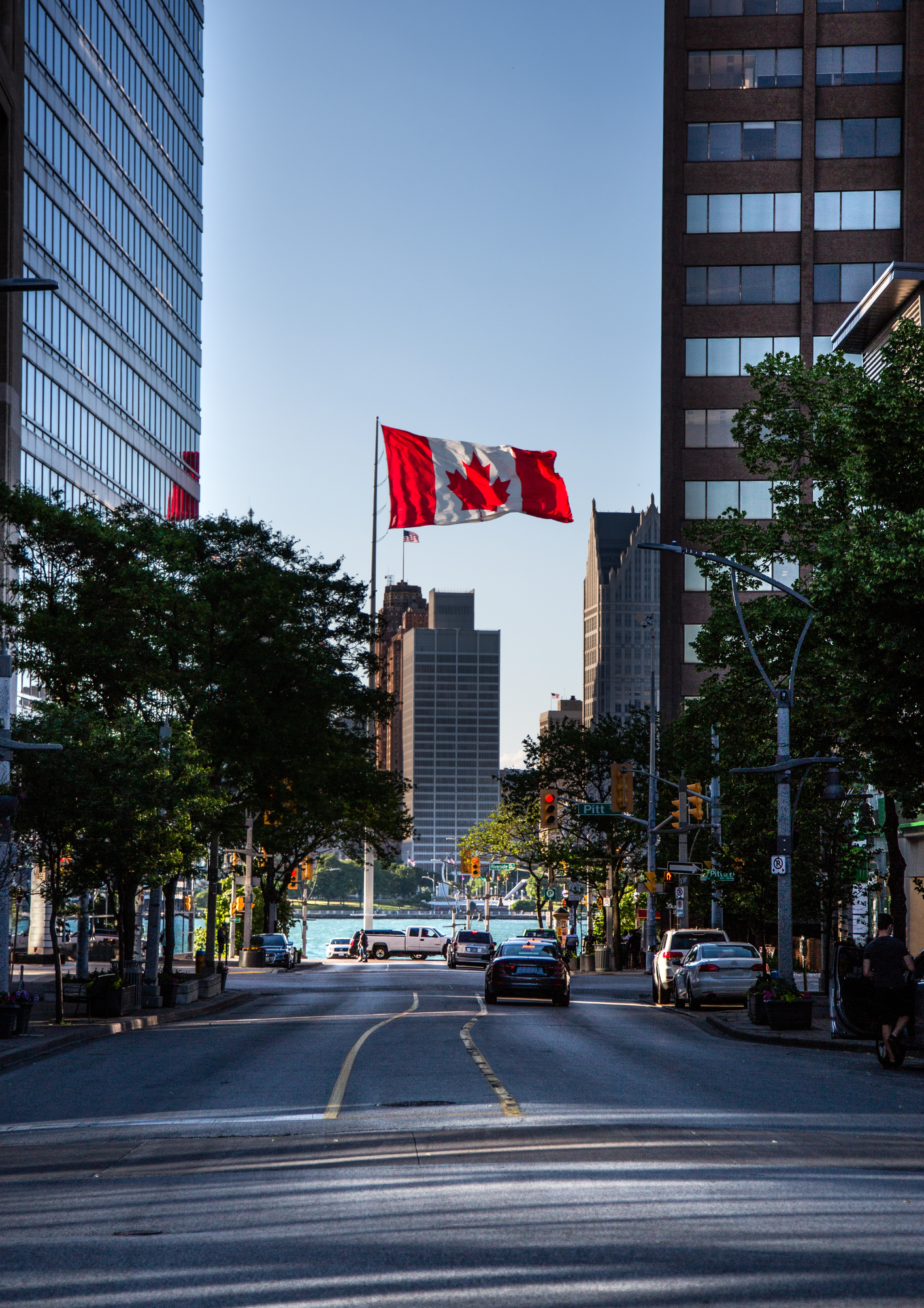 Ontario cityscape with a Canadian flag, representing legal services and lawyers available in Ontario.