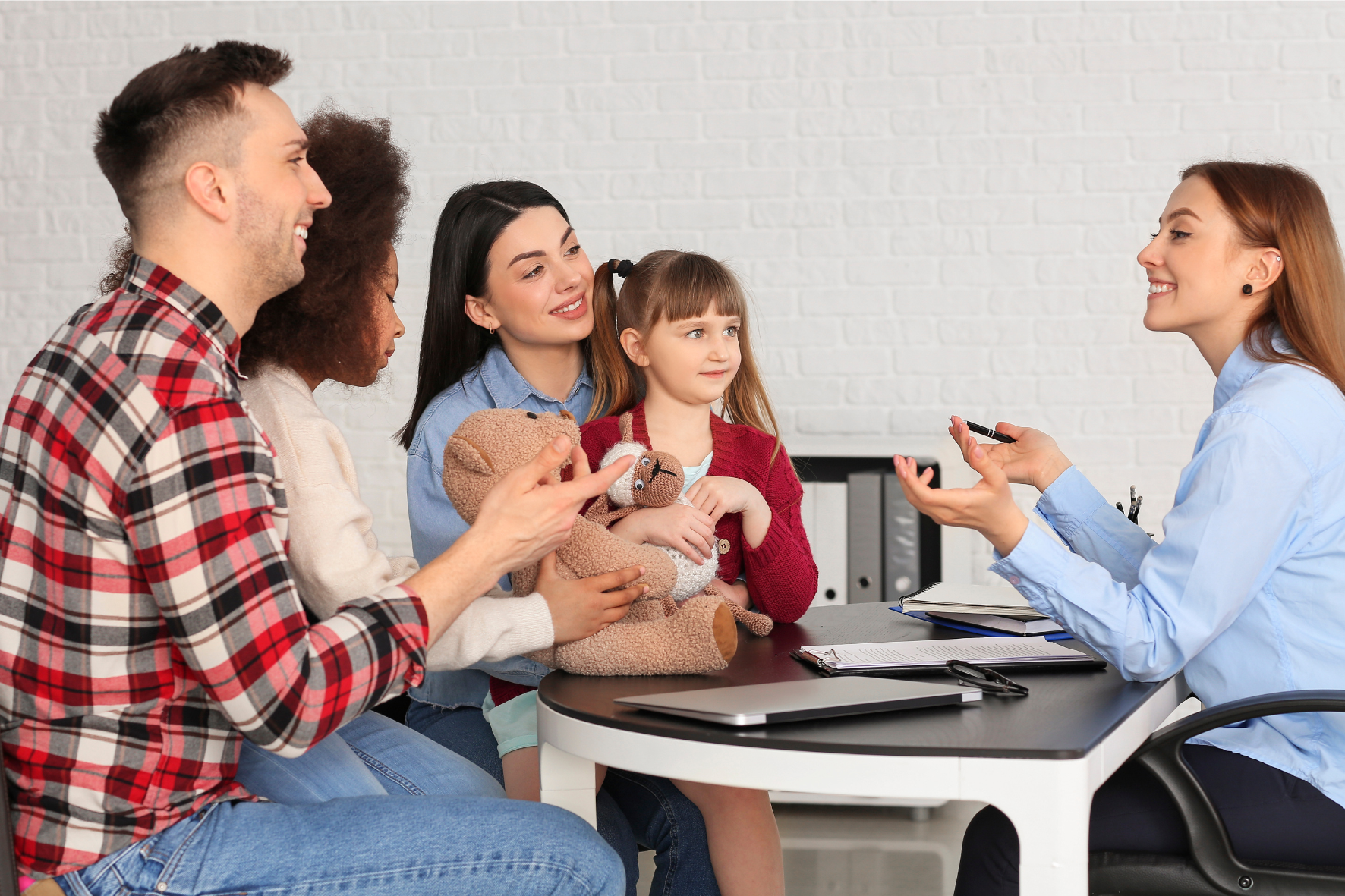 A happy family consulting with a legal professional about child custody, ensuring the best interests of the child in the custody process.