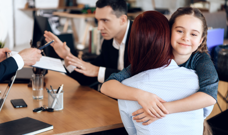 A mother hugging her smiling daughter during a custody discussion, while a lawyer mediates between parents in an Ontario child custody case.