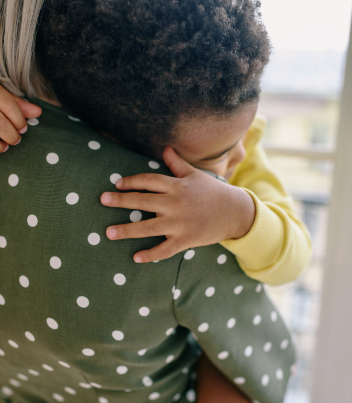 Mother hugging her child, symbolizing emotional support and stability after a child support agreement.