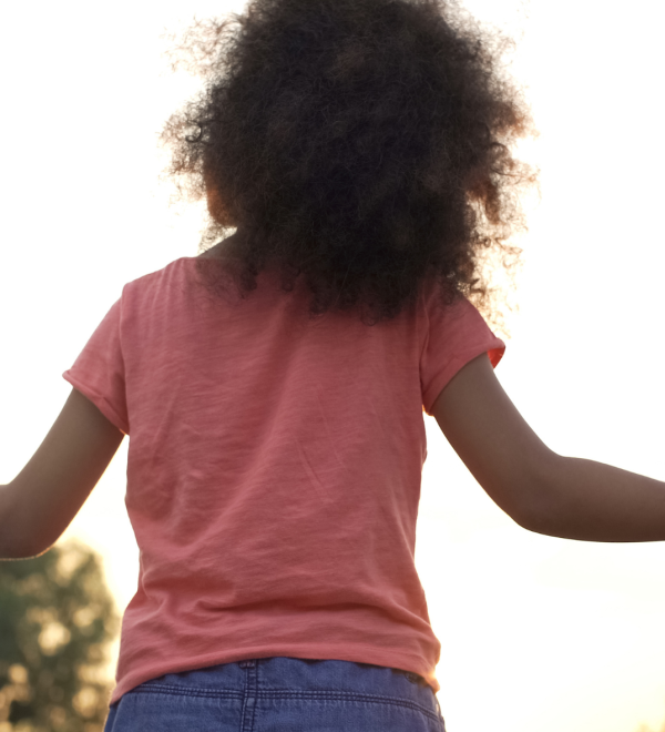 A child holding hands with both parents, symbolizing shared financial responsibility and child support in Ontario.